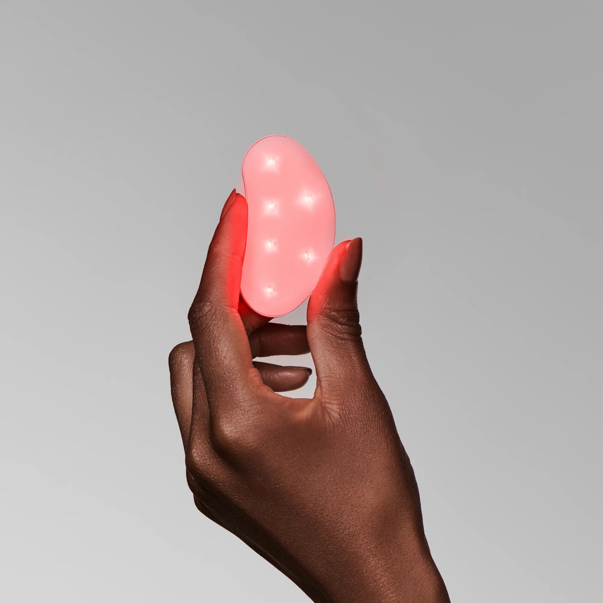omnilux mini eye brightener being held in hand at heaven on earth