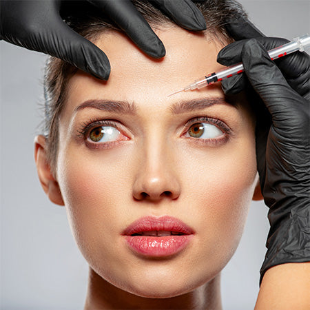 what to do for botched botox - by heaven on earth aspen . woman with a needle and syringe over her eyebrow 