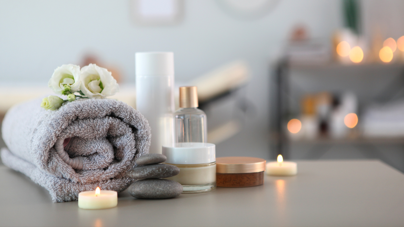 image of relaxing spa towel, candles, and products to showcase the massage enhancements available at heaven on earth to customize your aspen massage. 
