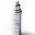 bottle of the KrX Mela Defense Whitening Serum with serum dripping off its spout sold at heaven on earth aspen