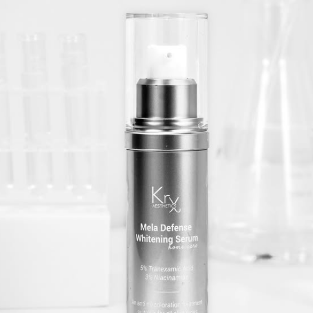 bottle of the KrX Mela Defense Whitening Serum in front of glass beakers sold at Heaven on earth aspen.