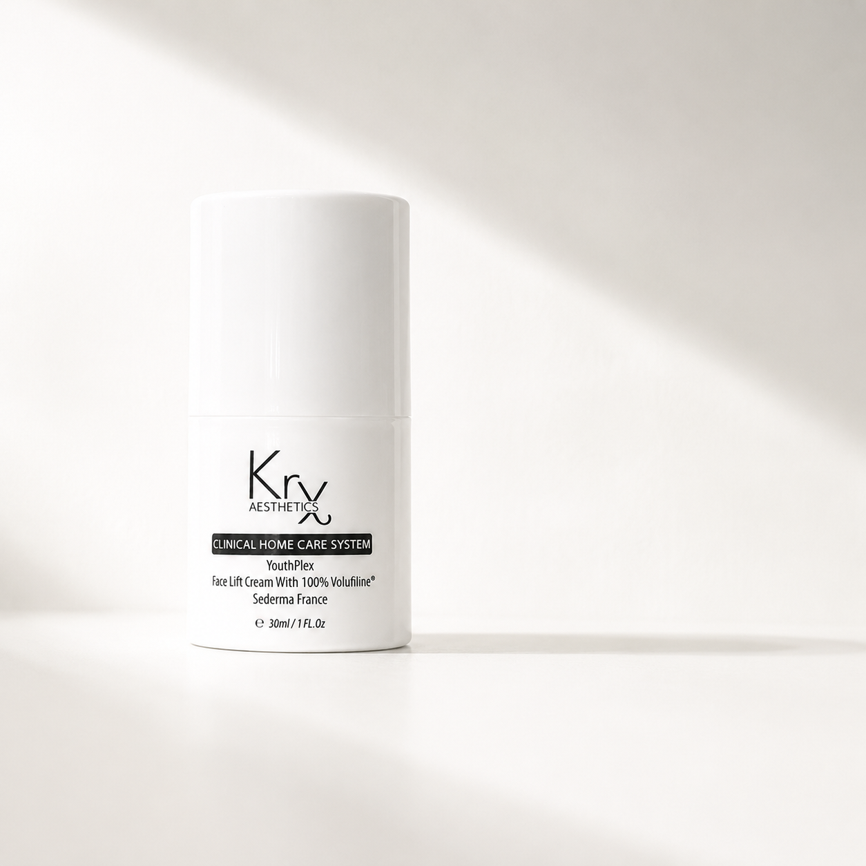 A white  cosmetic bottle labeled KrX Youthplex Face Lift Cream' standing on a white surface with soft diagonal shadows across the background.