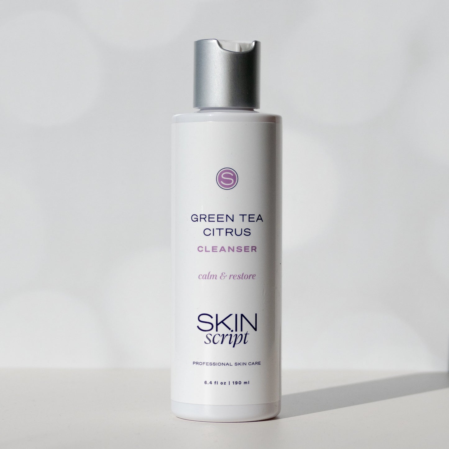 Skincare cleanser bottle labeled 'Green Tea Citrus' by 'Skin Script' on a light gray background available at heaven on earth aspen