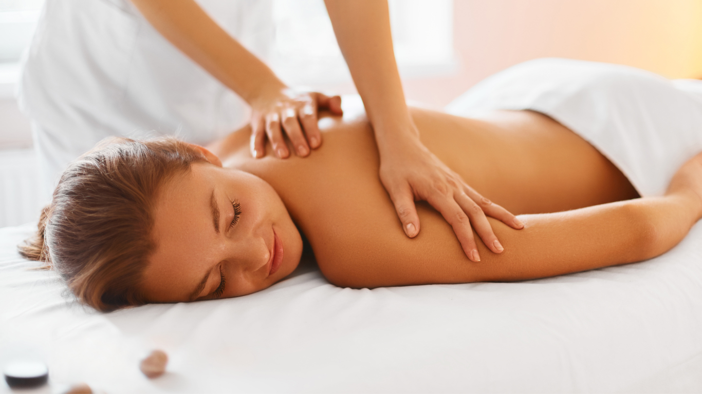woman receiving massage in spa