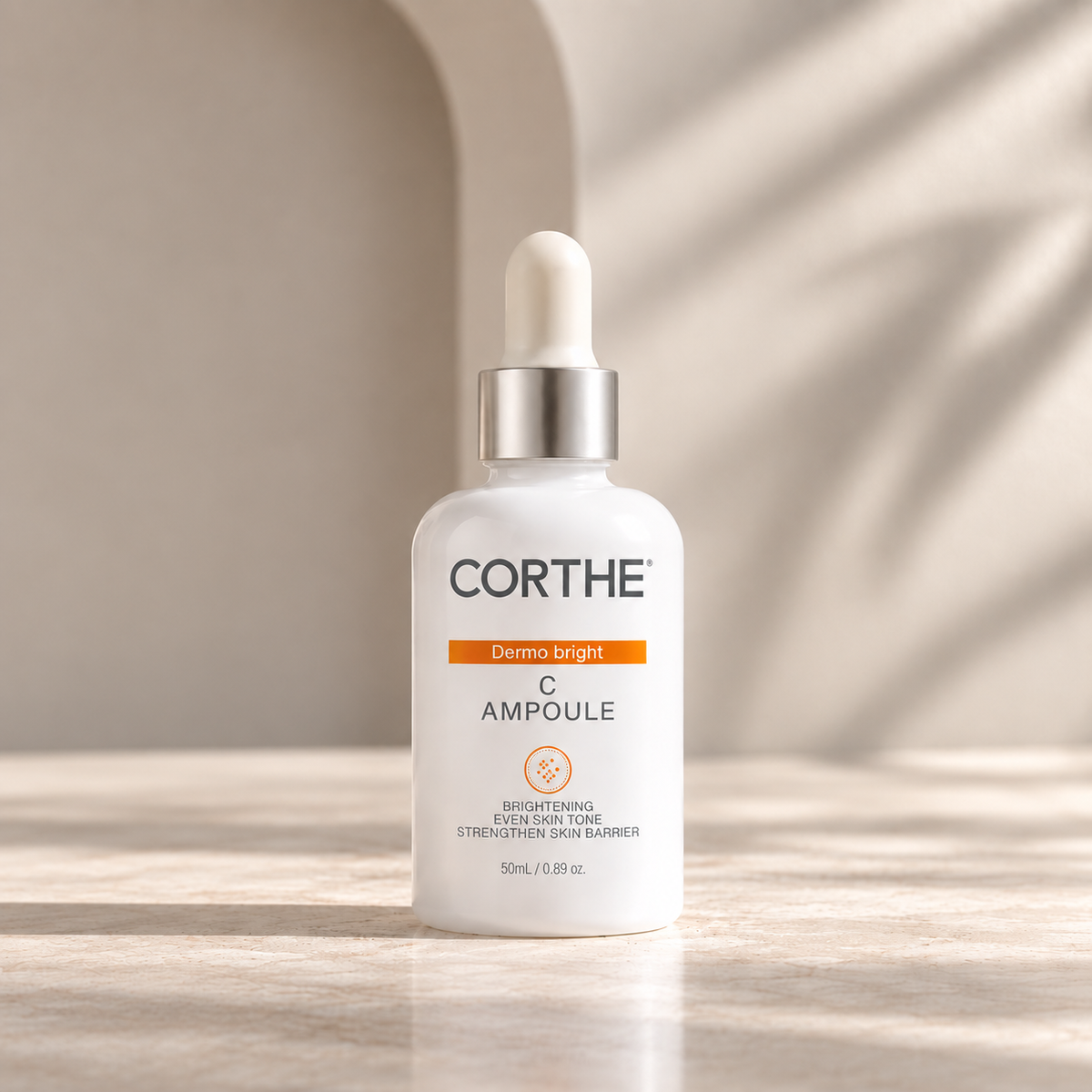 CORTHE C Ampoule brightening serum in a white dropper bottle with a silver collar, set on a light stone surface with soft shadow play.