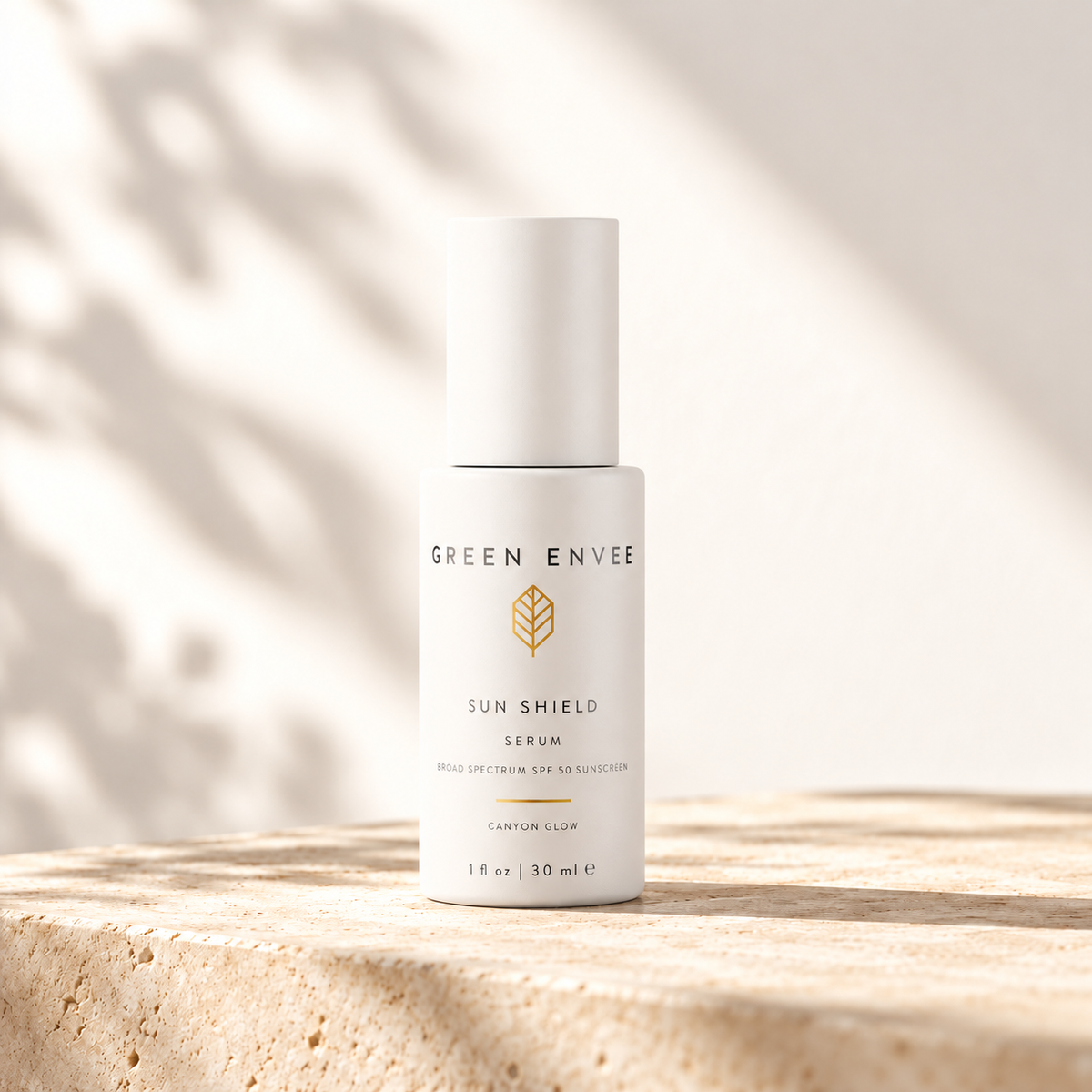 green envee sunshield serum in canyon glow on a beige shelf with beautiful lighting
