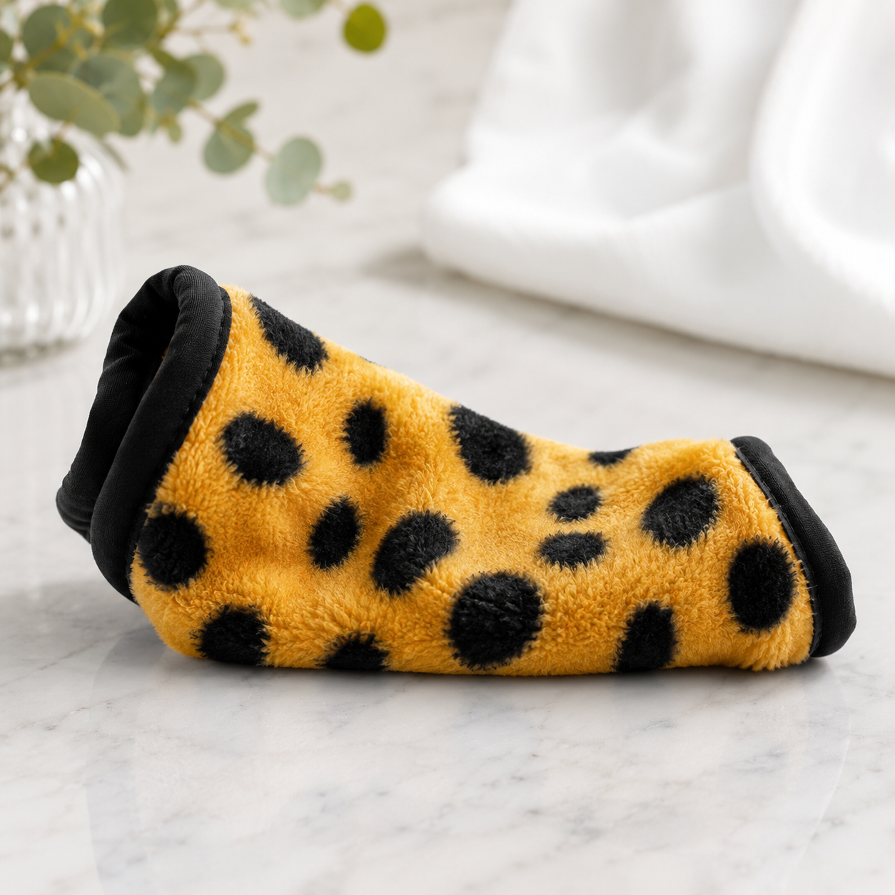 a rolled towel in cheetah print on counter
