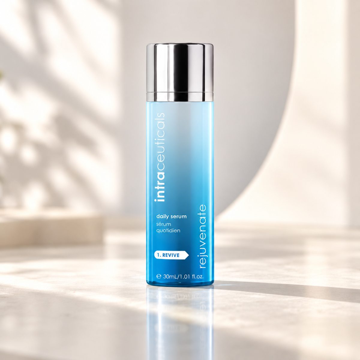 A 30ml bottle of Intraceuticals Daily Serum, featuring a light blue gradient body and a reflective silver cap, set on a marble surface with soft shadows.