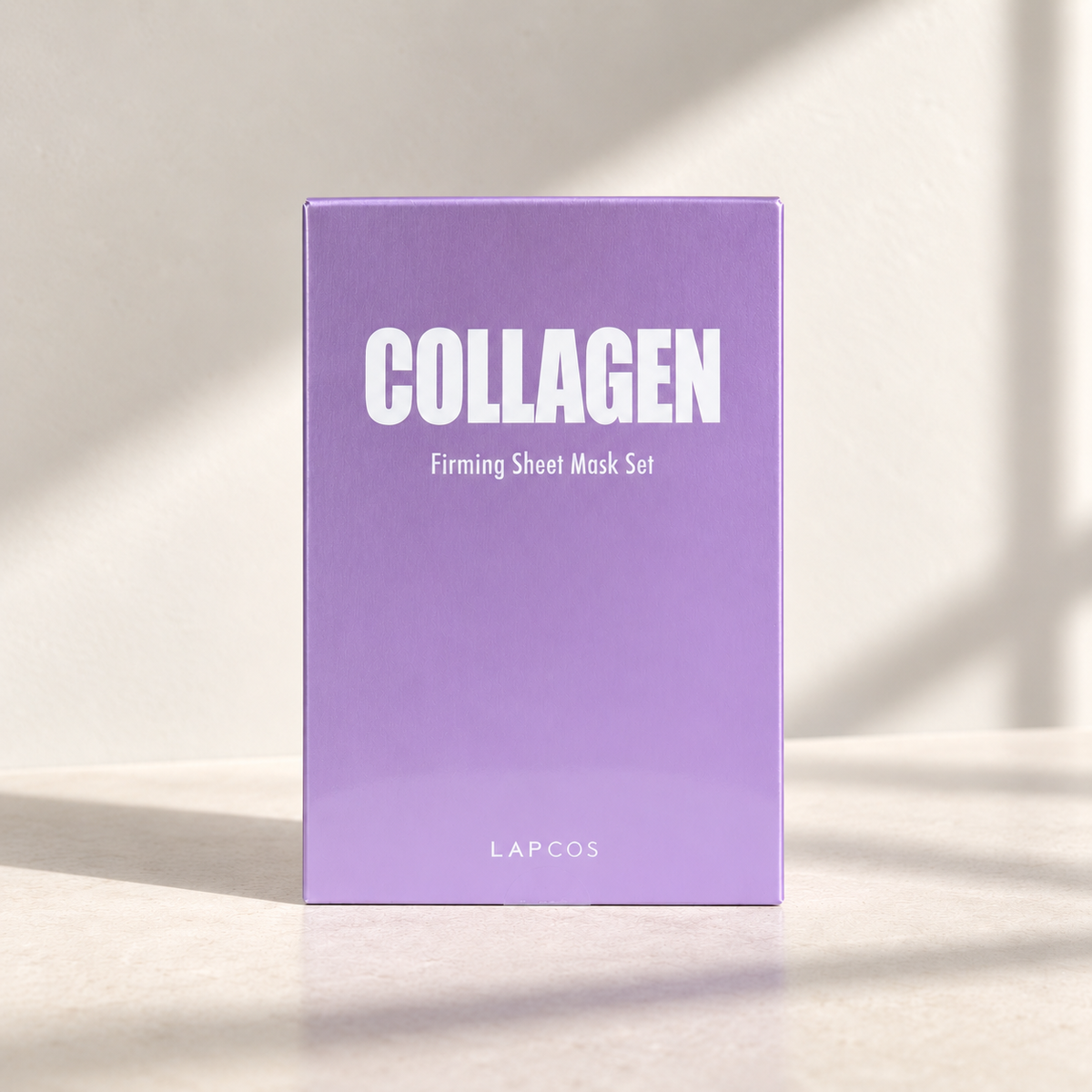 the lacos collagen sheet mask against a beige backdrop, linear shadows and soft lighting 
