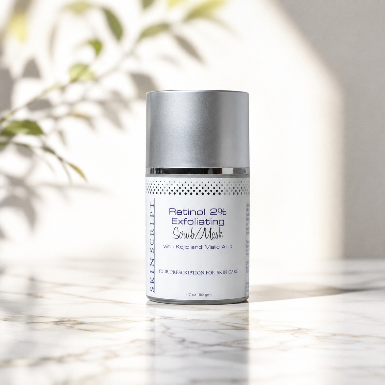 A silver and white cosmetic bottle of SKINSCRIPT Retinol 2% Exfoliating Crë Mask, set on a light marble surface with soft, natural leaf shadows in the background.