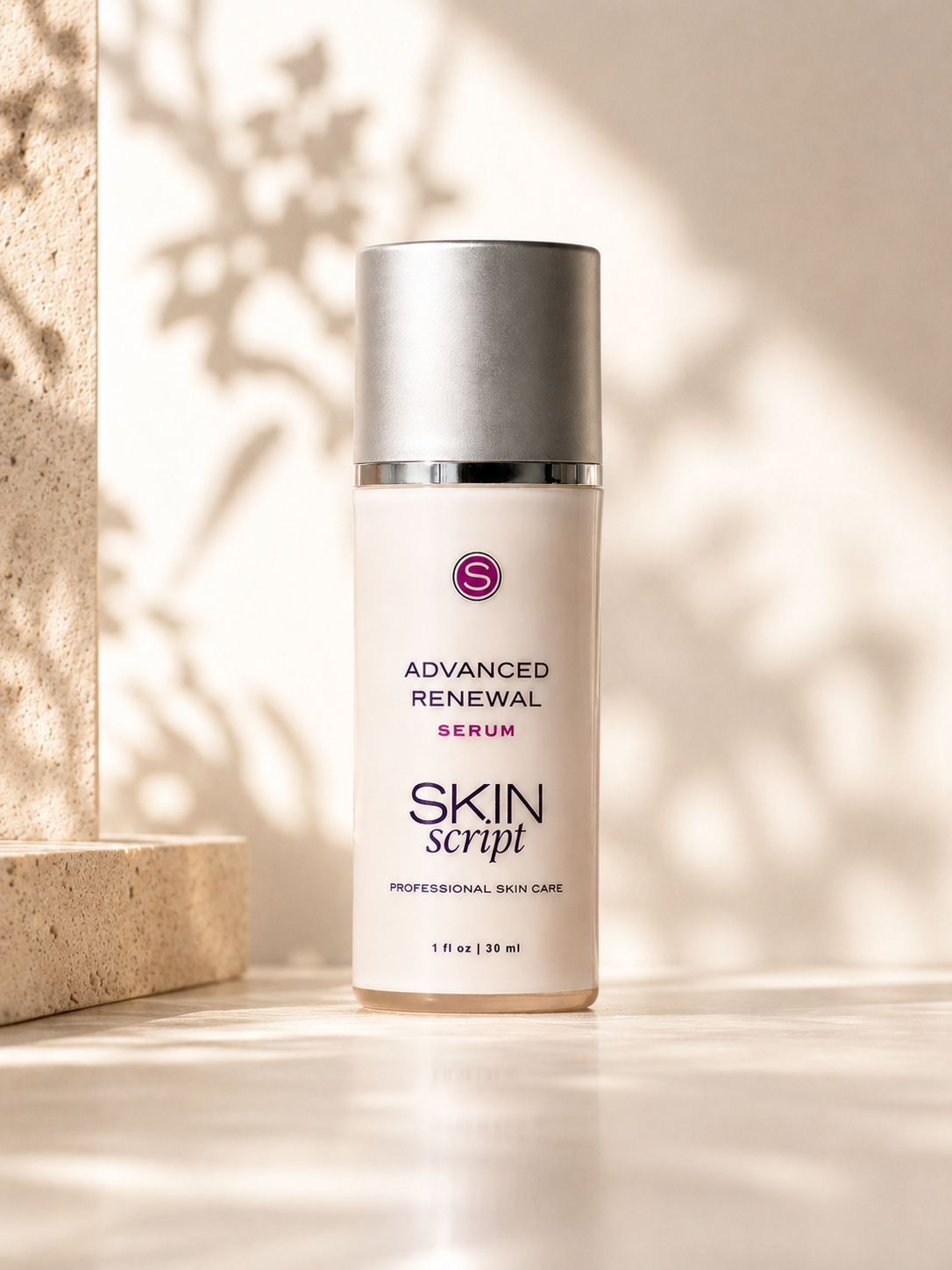A bottle of Skin Script Advanced Renewal Serum standing upright on a light surface with warm sunlight and leaf shadows cast across it. The bottle is off-white with a metallic silver cap and a small purple circular logo.