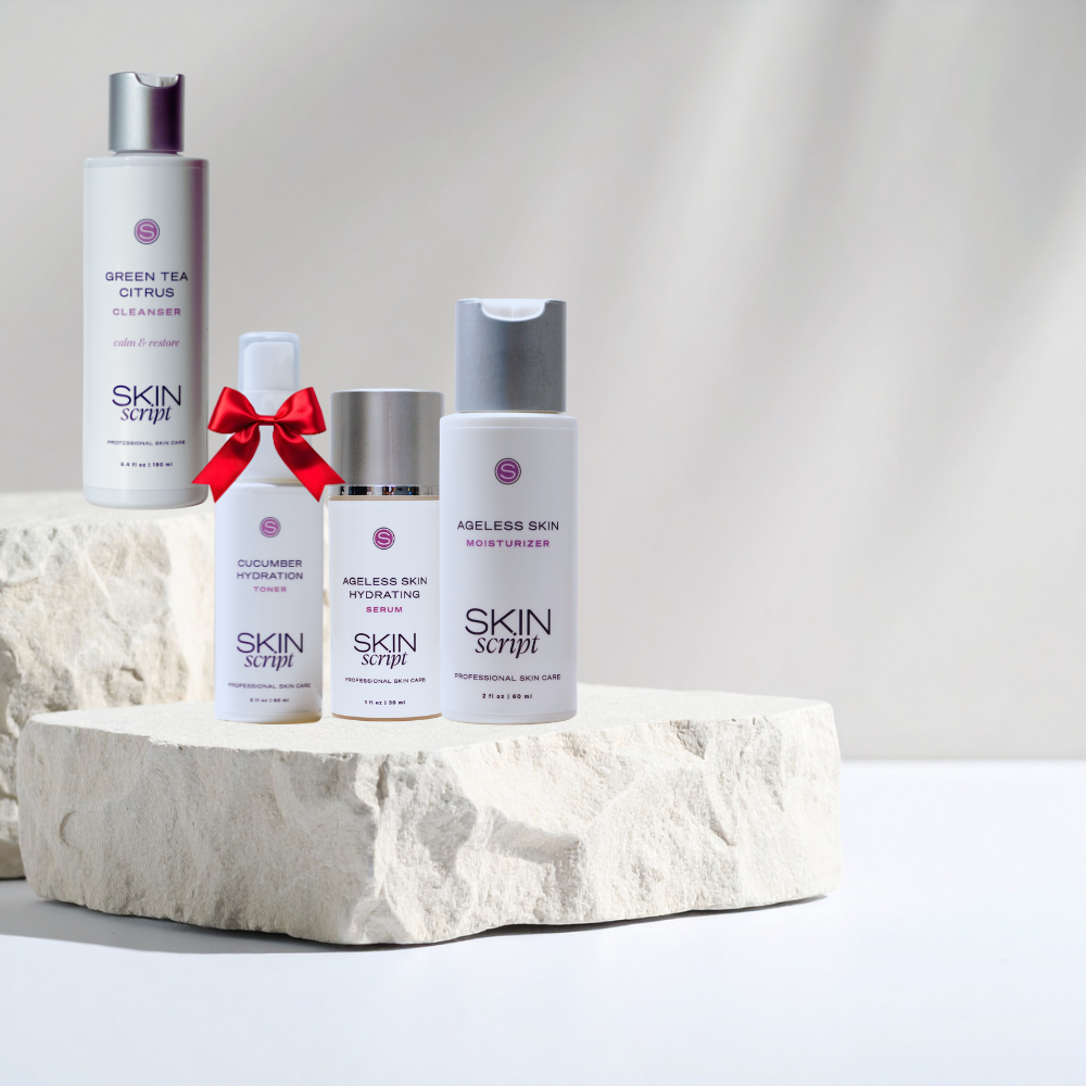 Collection of Skin Script skincare products on a stone surface with a neutral background