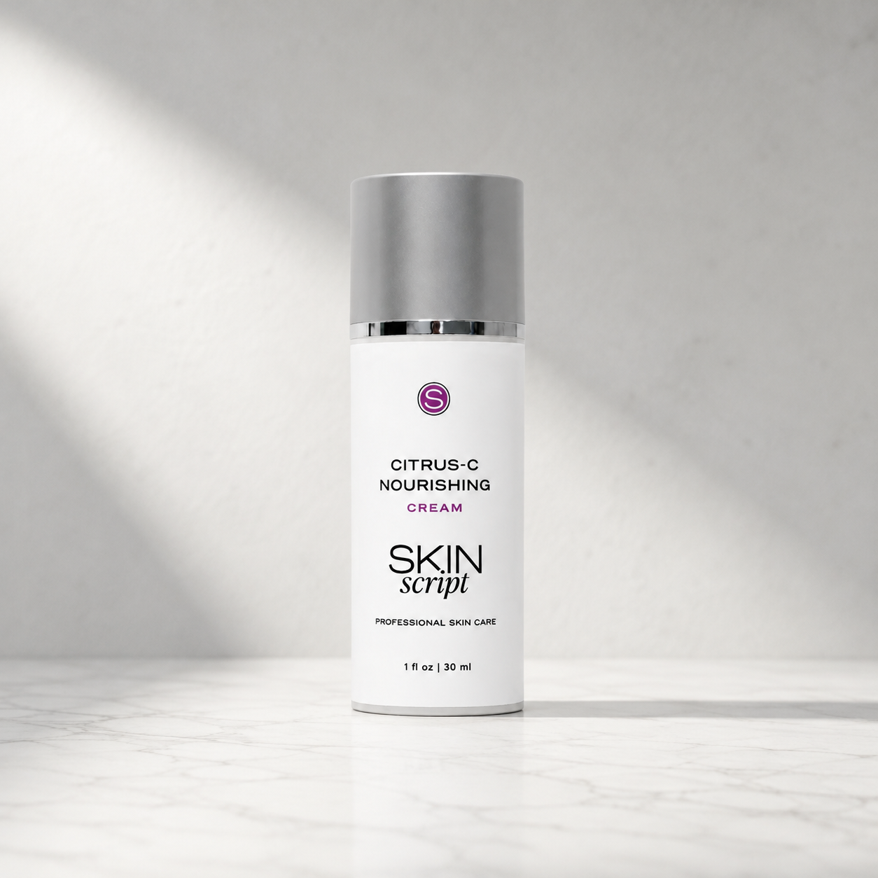 a white bottle with silver cap reads 'citrus -c nourishing cream - skin-script' with a a spotlight from the top  left 