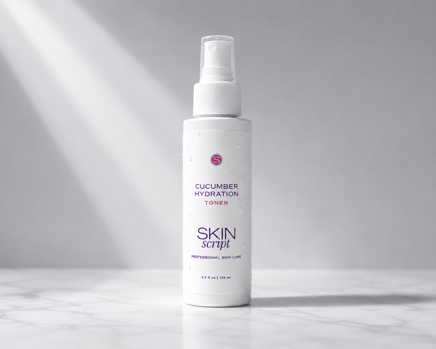 bottle of skin script hydration toner on a grey and white marble slab with a grey background and a beam of light highlighting the bottle 