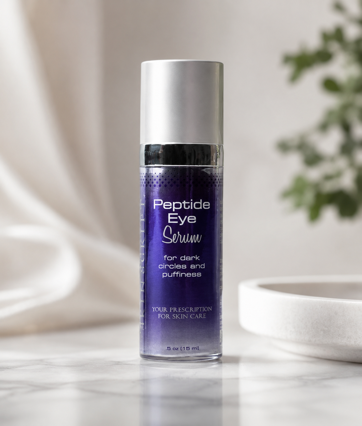 Peptide Eye Serum bottle on a marble surface with a neutral background