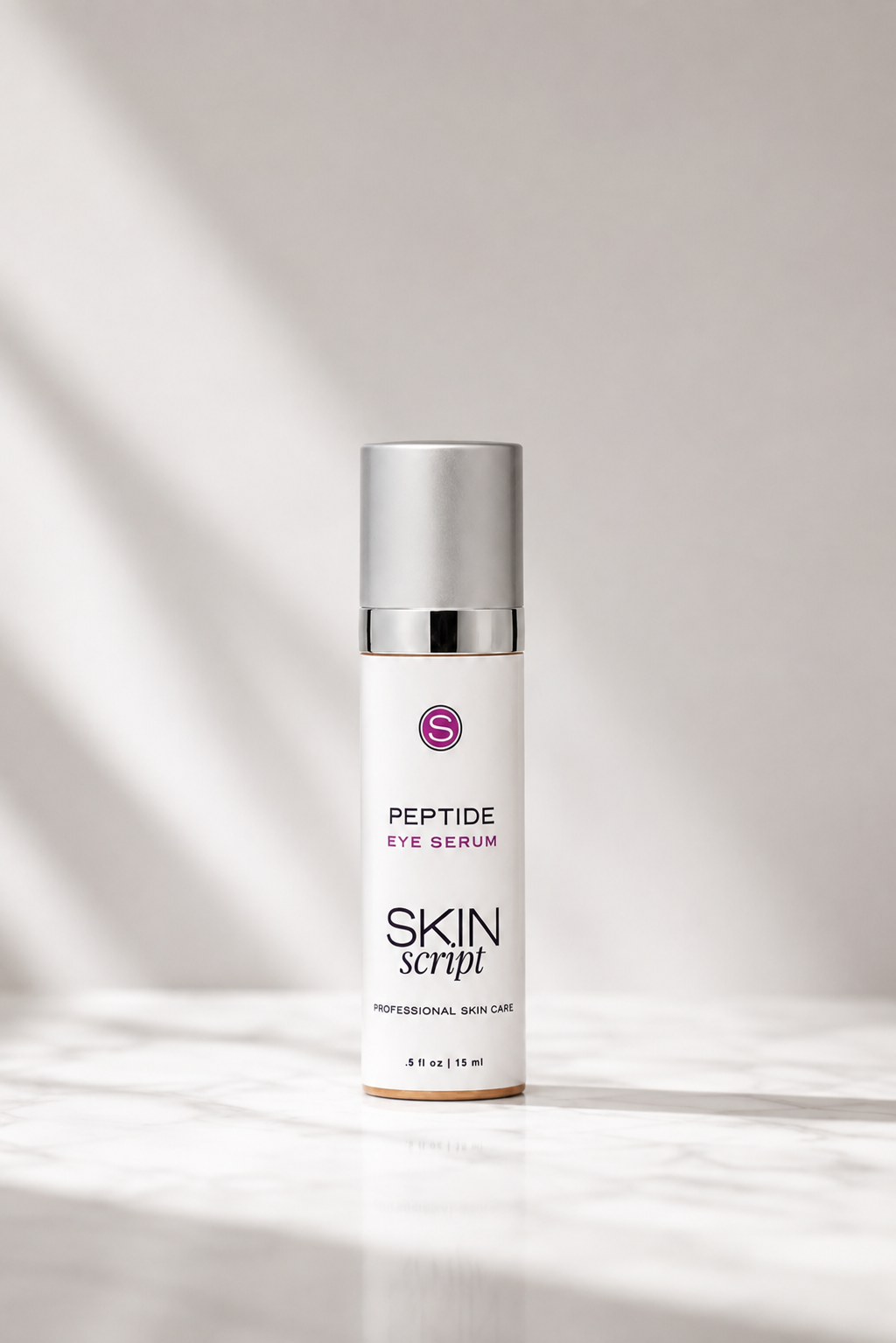 A white bottle of Skin script Peptide Eye Serum with a silver cap, standing on a light marble surface with soft diagonal shadows.
