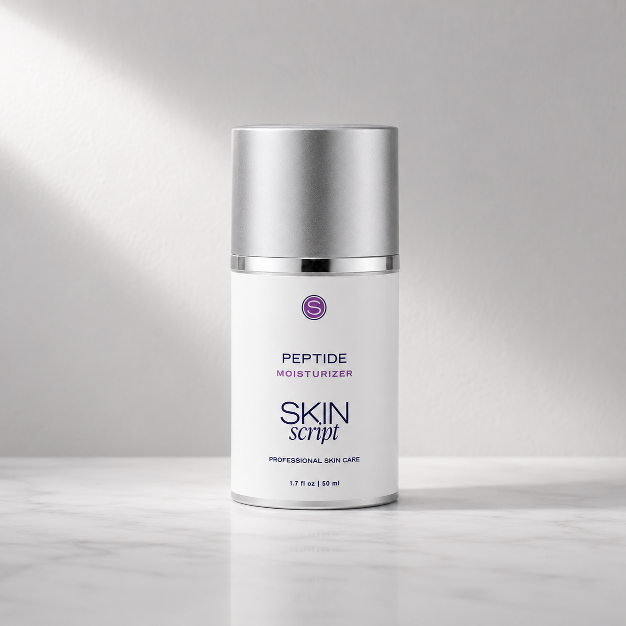 A white bottle of Skin Script Peptide Moisturizer with a metallic silver cap, set on a light marble surface against a gray background with soft diagonal light rays.