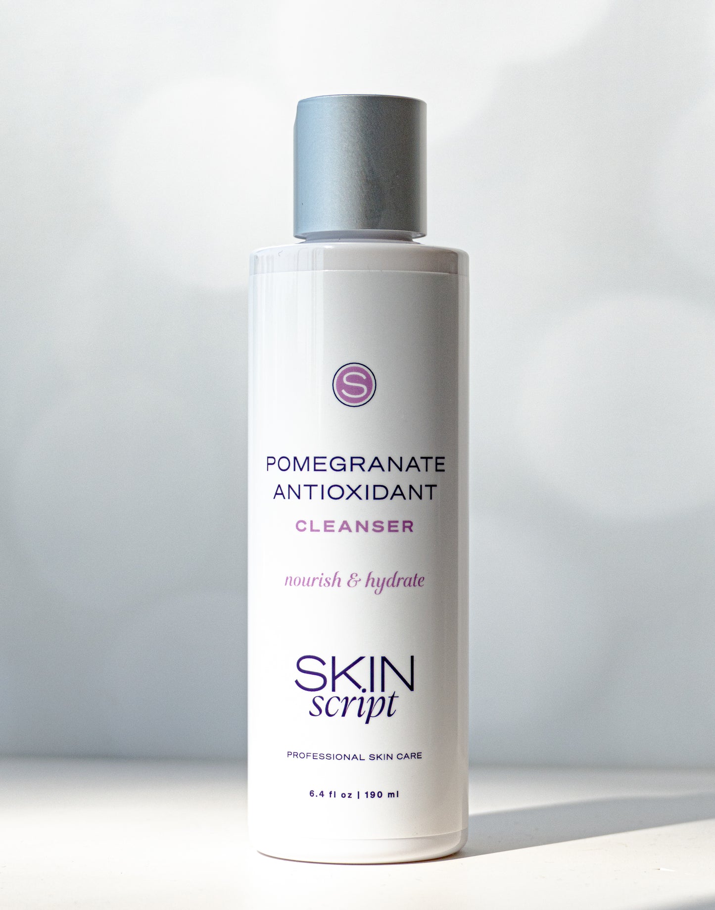 Skincare bottle labeled 'Pomegranate Antioxidant Cleanser' by 'Skin Script' on a light background available at heaven on erth aspen 