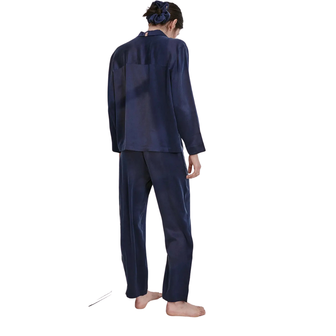 model wearing the lunya washable silk long sleeve pant set in deep blue available at heaven on earth 
