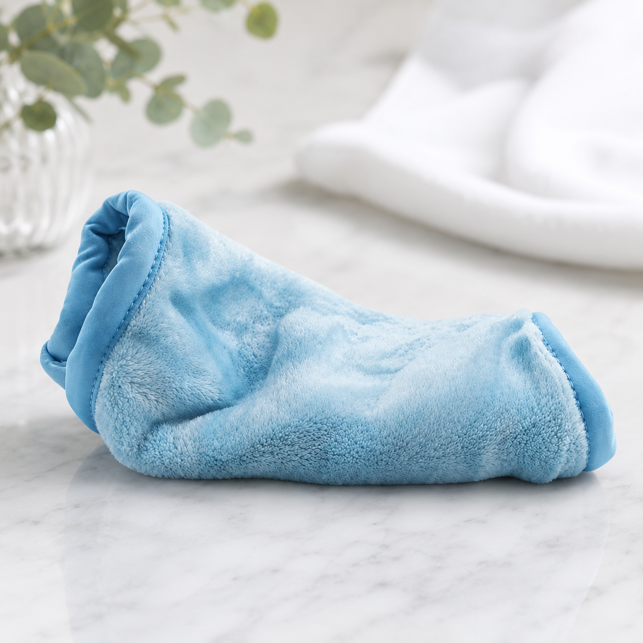 the makeup eraser in blue on a white counter
