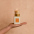 Hand holding a votivo spiced chai votive candle 
